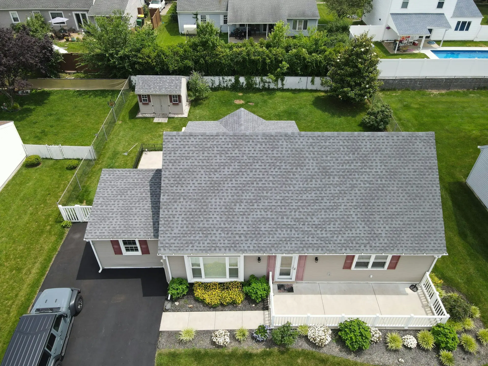 Aerial view of a home with a newly installed gray architectural shingle roof