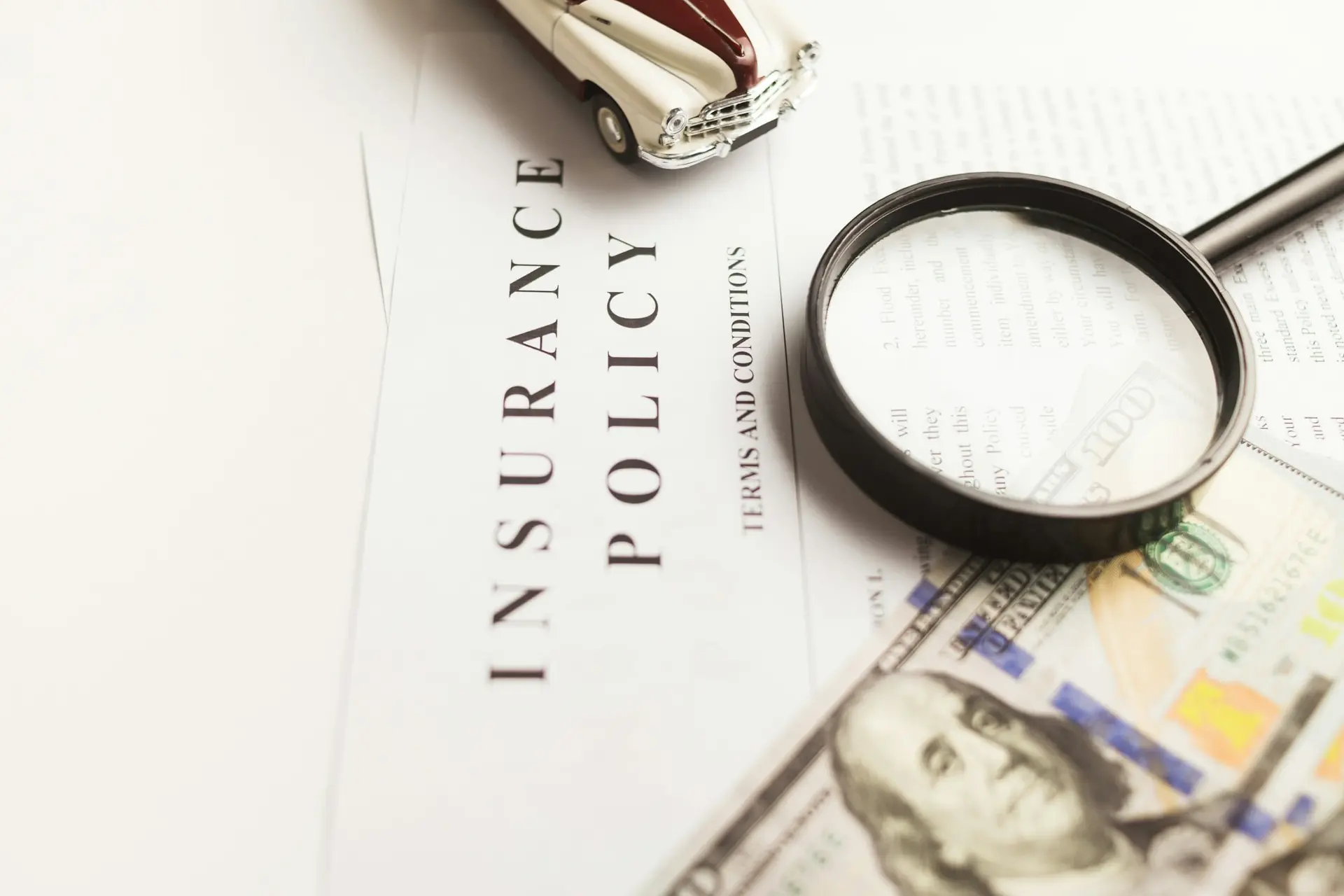 Homeowner insurance policy under a magnifying glass during a roof claim review