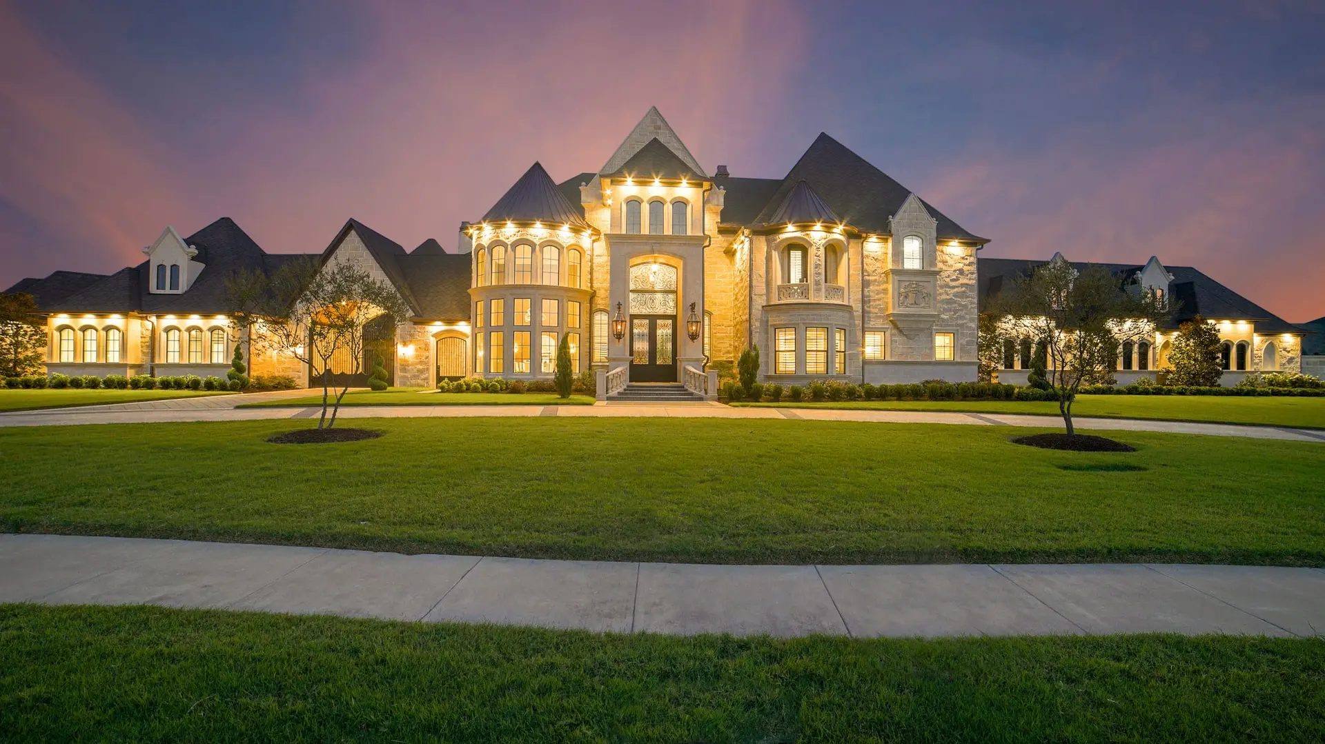 Estate home in the Tulsa area at dusk with a new dark architectural shingle roof